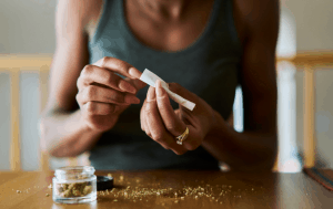 a young woman using cannabis as she researches mental health relations between cannabis and mental health disorders